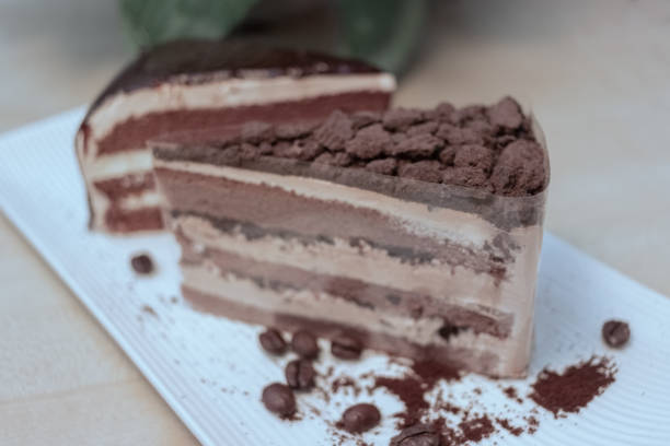 istock At breakfast, a chocolate mousse cake, chocolate powder and coffee beans, coffee powder, white tray 1145377626