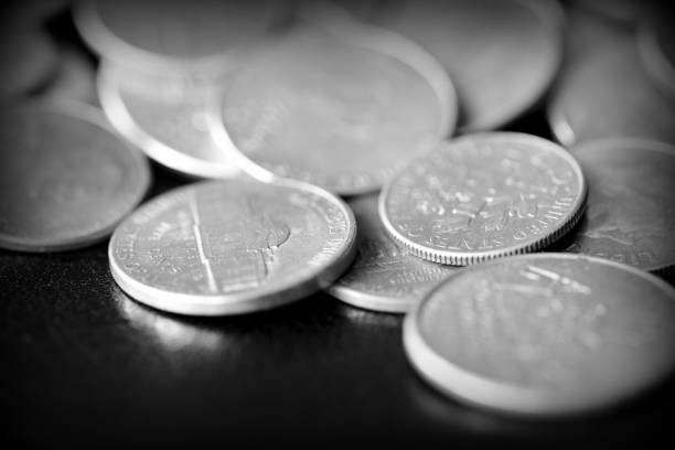 istock American cents on a dark background close up. Black amd white 1145377640