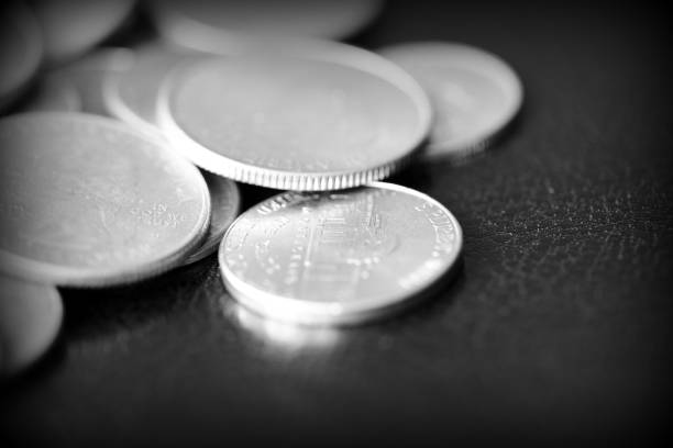 istock American cents on a dark background close up. Black amd white 1145377655