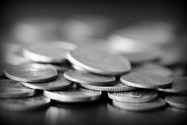 istock American cents on a dark background close up. Black amd white 1145377665