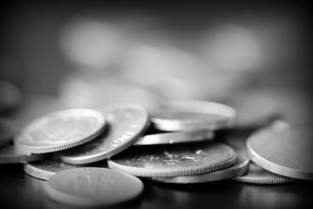 istock American cents on a dark background close up. Black amd white 1145377669