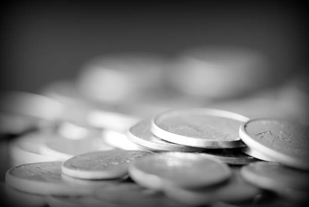 istock American cents on a dark background close up. Black amd white 1145377675
