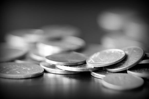 istock American cents on a dark background close up. Black amd white 1145377676
