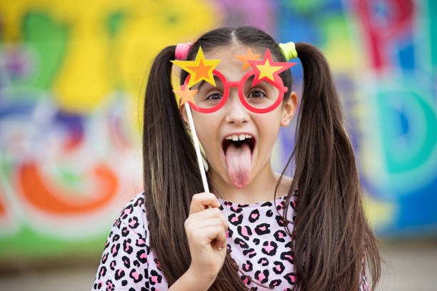 Fun young girl sticking out her tongue stock photo