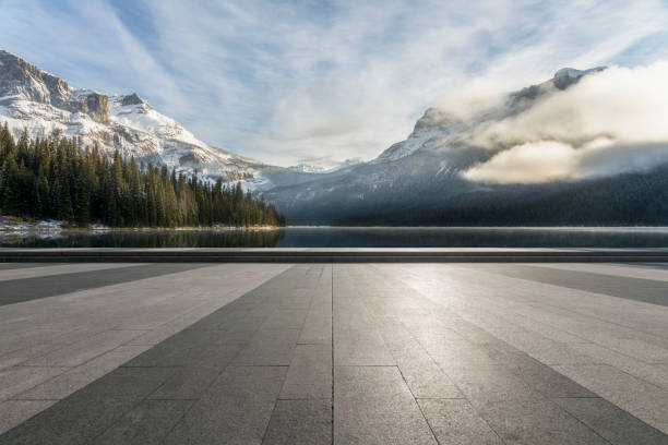 istock empty pavement front Of idyllic lake and mountains against sky 1145381808