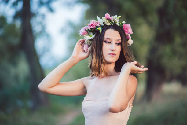 istock Young woman with wreath outdoors enjoying life. 1145383895
