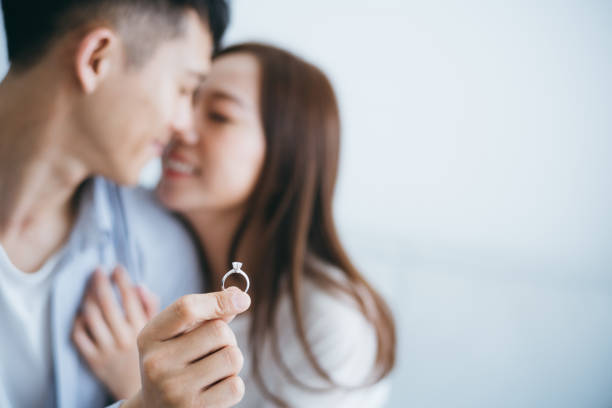 Man with engagement ring proposing marriage to girlfriend in new house, they are kissing with smile Man with engagement ring proposing marriage to girlfriend in new house, they are kissing with smile Engagement Rings stock pictures, royalty-free photos & images