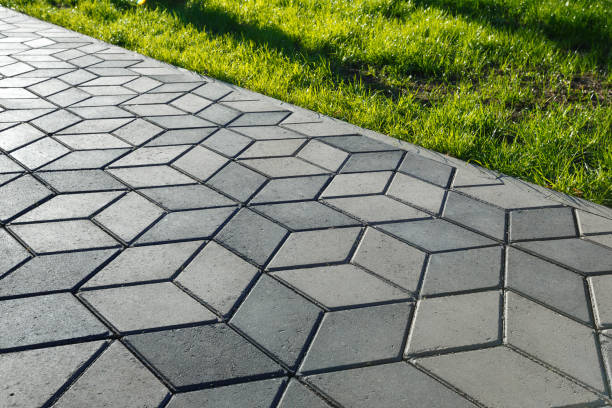 The footpath in the park is paved with diamond shaped concrete tiles. stock photo