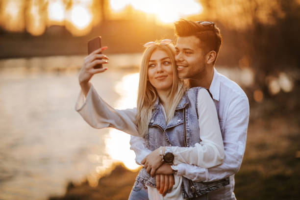 istock Happy young couple taking selfie by the river 1145389727