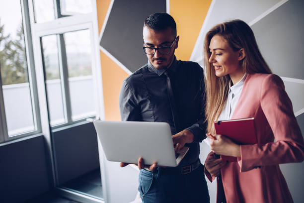 istock Young couple working together in business office. 1145391304