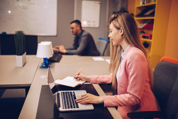 istock Young couple working together in business office. 1145391399