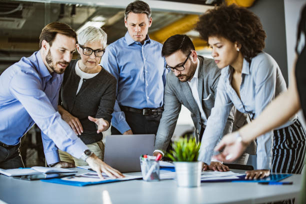 istock Team of entrepreneurs analyzing reports in the office. 1145392564