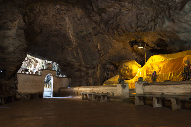 istock Reclining Buddha with light shinning through cave 1145392783