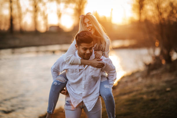 istock Loving young couple having fun by the river 1145393430
