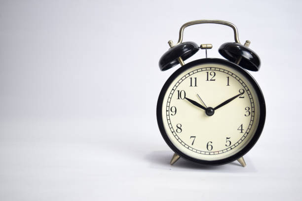 istock Clock ticking to 10 o'clock isolated on white background 1145393573