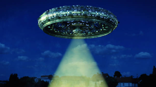 istock UFO, alien spaceship with light beam hovering in the night sky, extraterrestrial visitors with flying saucer 1145394320