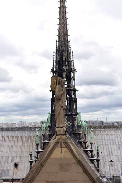 Notre Dame Cathedral. View of the Spire, La Fleche, and lead clad wooden roofs. Paris, France. Paris, France, 13 August 2018. Notre Dame Cathedral. View of the Spire with Apostles and Evangelists statues on lead clad wooden roofs. View from towers viewpoint. fleche stock pictures, royalty-free photos & images