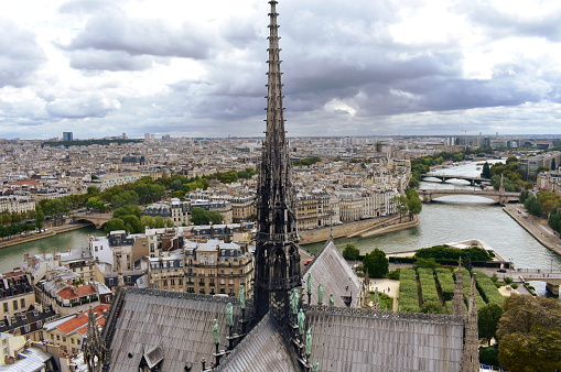 Paris, France, 13 August 2018. Notre Dame Cathedral. View of the Spire with Apostles and Evangelists statues on lead clad wooden roofs. View from towers viewpoint.