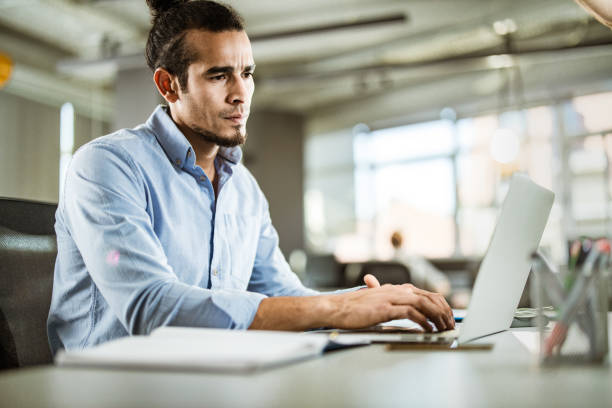 istock Young Hispanic businessman working on a computer in the office. 1145395804