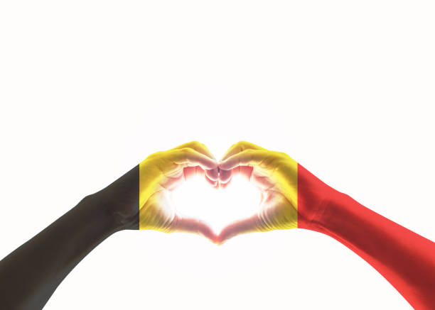 istock Belgian black yellow red flag pattern on people heart shaped hands (clipping path) on white background 1145396407