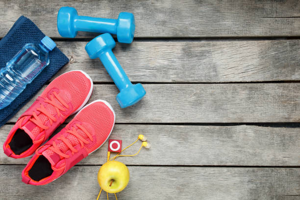istock Composition with sport shoes on wooden background 1145396614