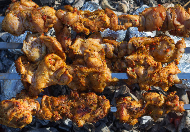 istock Chicken kebabs cooking on a BBQ. Close-up, selective focus. 1145397096