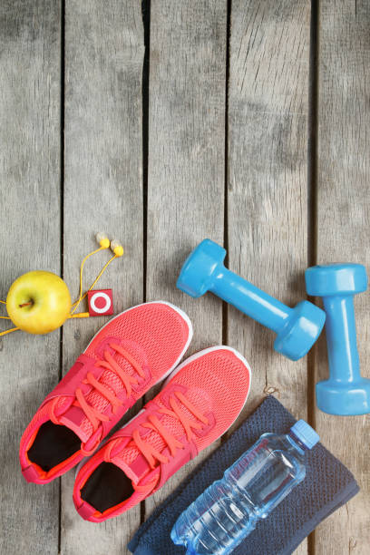 istock Composition with sport shoes on wooden background 1145397867