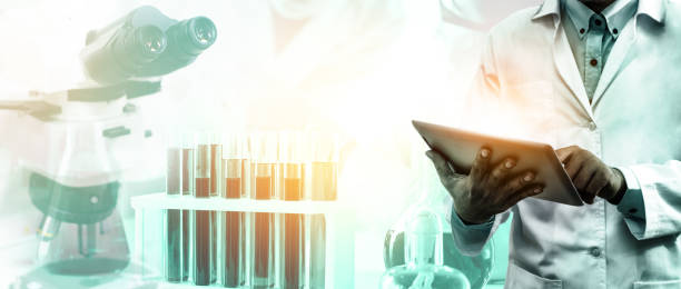 istock Research and development concept. Double exposure image of scientific and medical lab instrument, microscope, test tube and glass flask for microbiology and chemistry in laboratory for medicine study. 1145399789