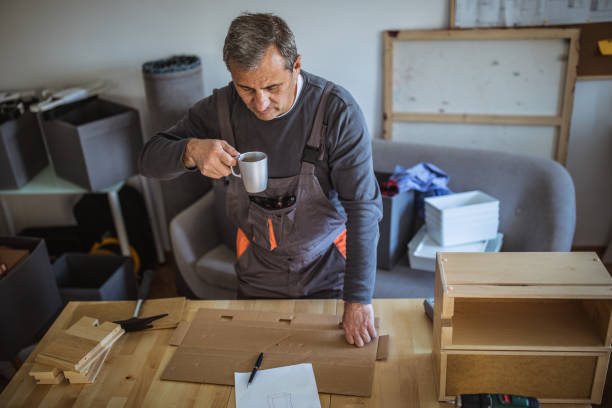 istock Man is reading the instructions for assembling furniture 1145404703