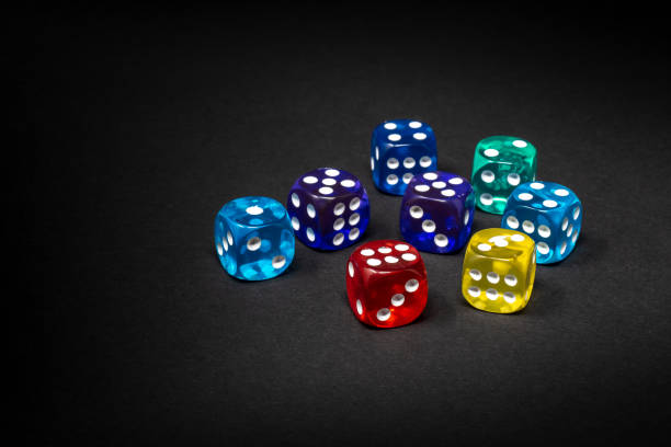 istock High Angle View Of Multi Colored Dices On Black Background 1145406364