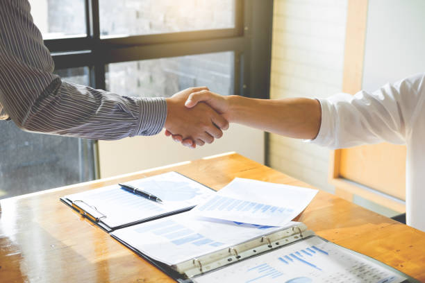 istock Cropped Image Of Colleagues Giving Handshake In Office 1145408145