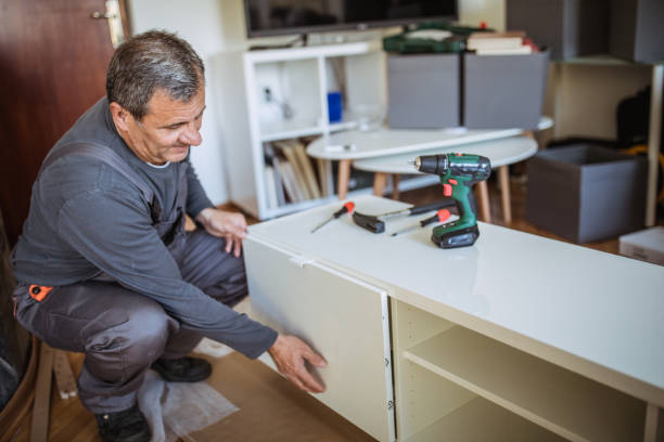 istock Mature man assembling furniture in new home 1145409252