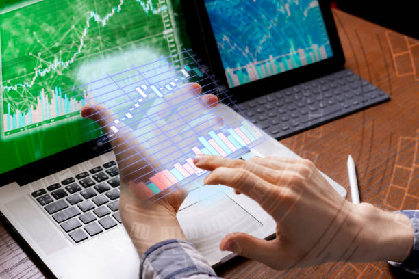istock young businessman broker watching on the stocks on his devices 1145410103