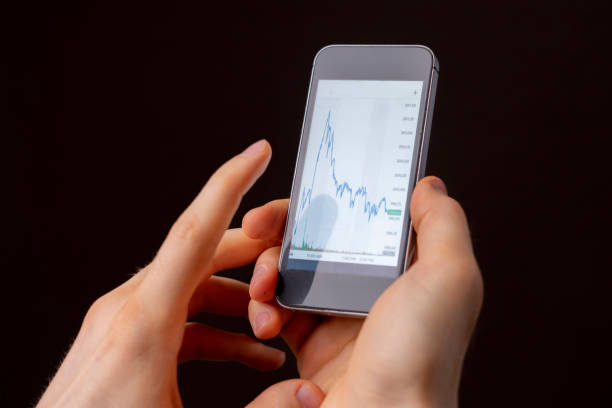 istock businessman or broker wathcing stocks via phone b 1145410109