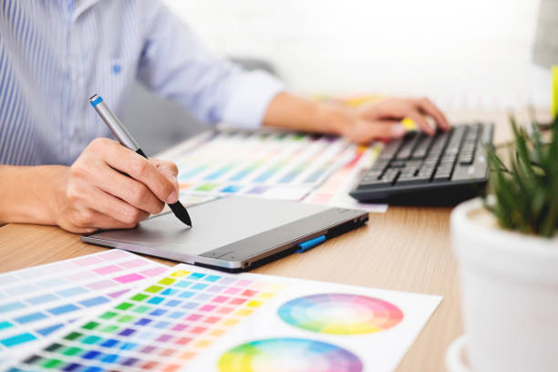 istock Midsection Of Businessman Using Graphic Tablet On Desk In Office 1145410162