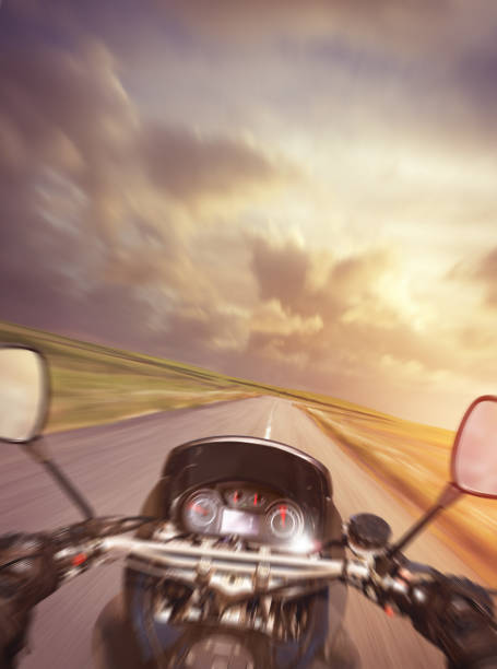 Motorbike going fast on the countryside road in sunset light