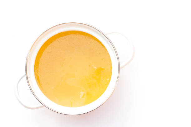 Bowl of chicken broth isolated on white background. stock photo