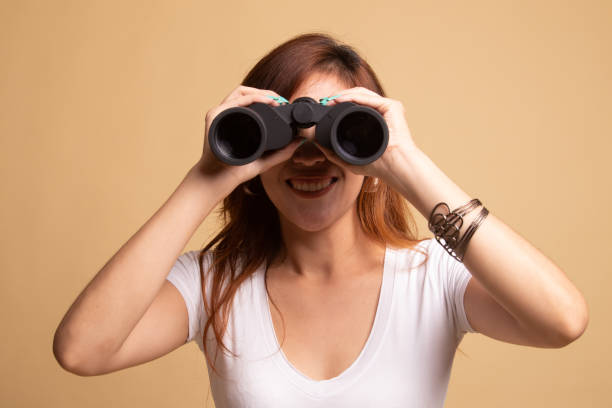 istock Young Asian woman with binoculars. 1145420726
