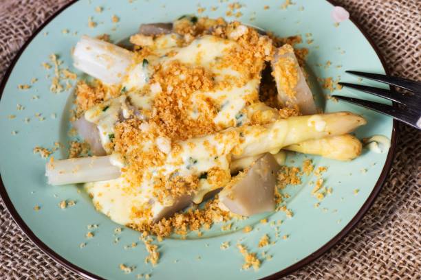 istock Boiled asparagus with breadcrumb and sauce. 1145422090