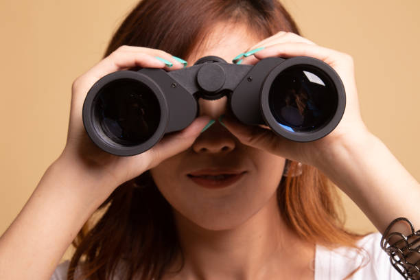 istock Young Asian woman with binoculars. 1145425053