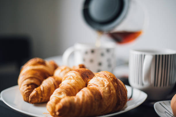 istock Breakfast with cup of coffee and croissants 1145425200