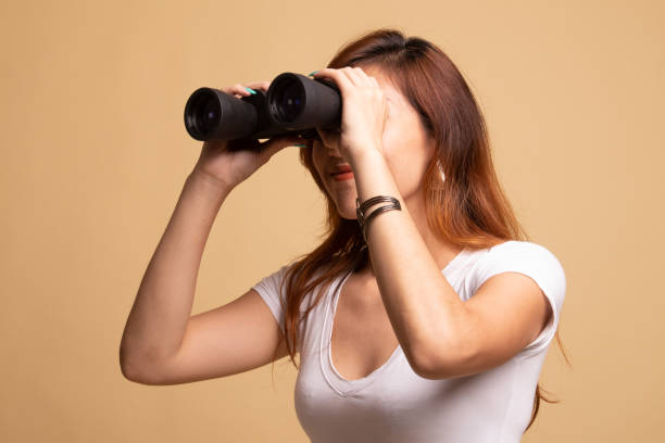 istock Young Asian woman with binoculars. 1145425206