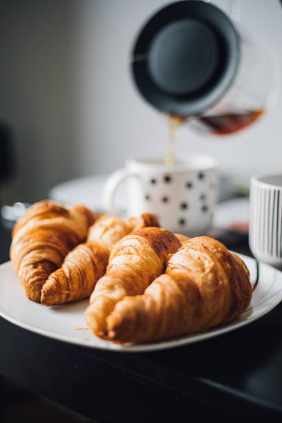 istock Breakfast with cup of coffee and croissants 1145425747