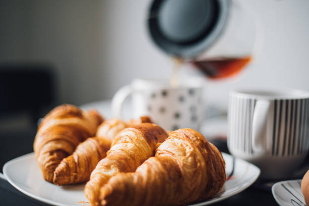istock Breakfast with cup of coffee and croissants 1145425748
