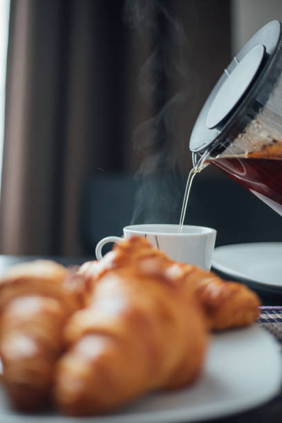 istock Breakfast with cup of coffee and croissants 1145426196