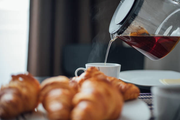 istock Breakfast with cup of coffee and croissants 1145426213