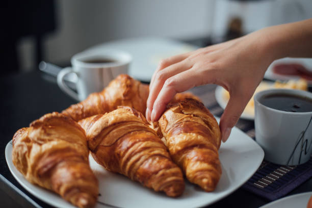 istock Breakfast with cup of coffee and croissants 1145426328