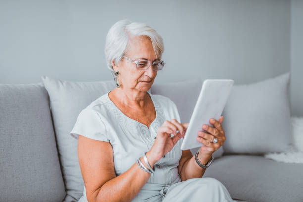 istock Senior woman using digital tablet at home. 1145427149