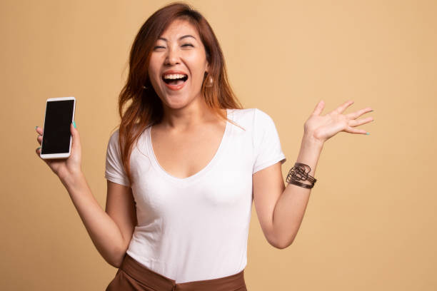 istock Young Asian woman with mobile phone. 1145428770