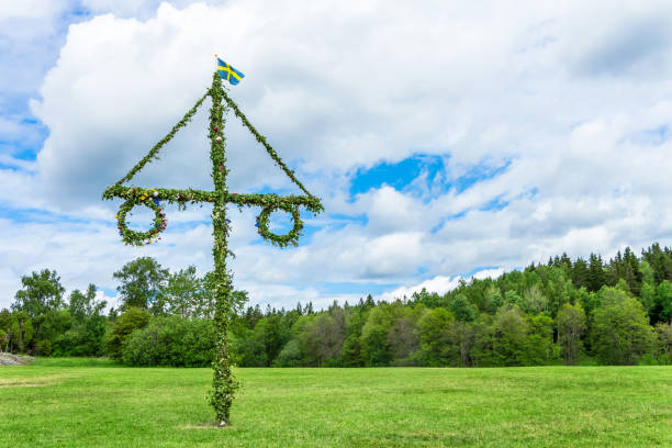 A Swedish maypole on a green summer meadow.